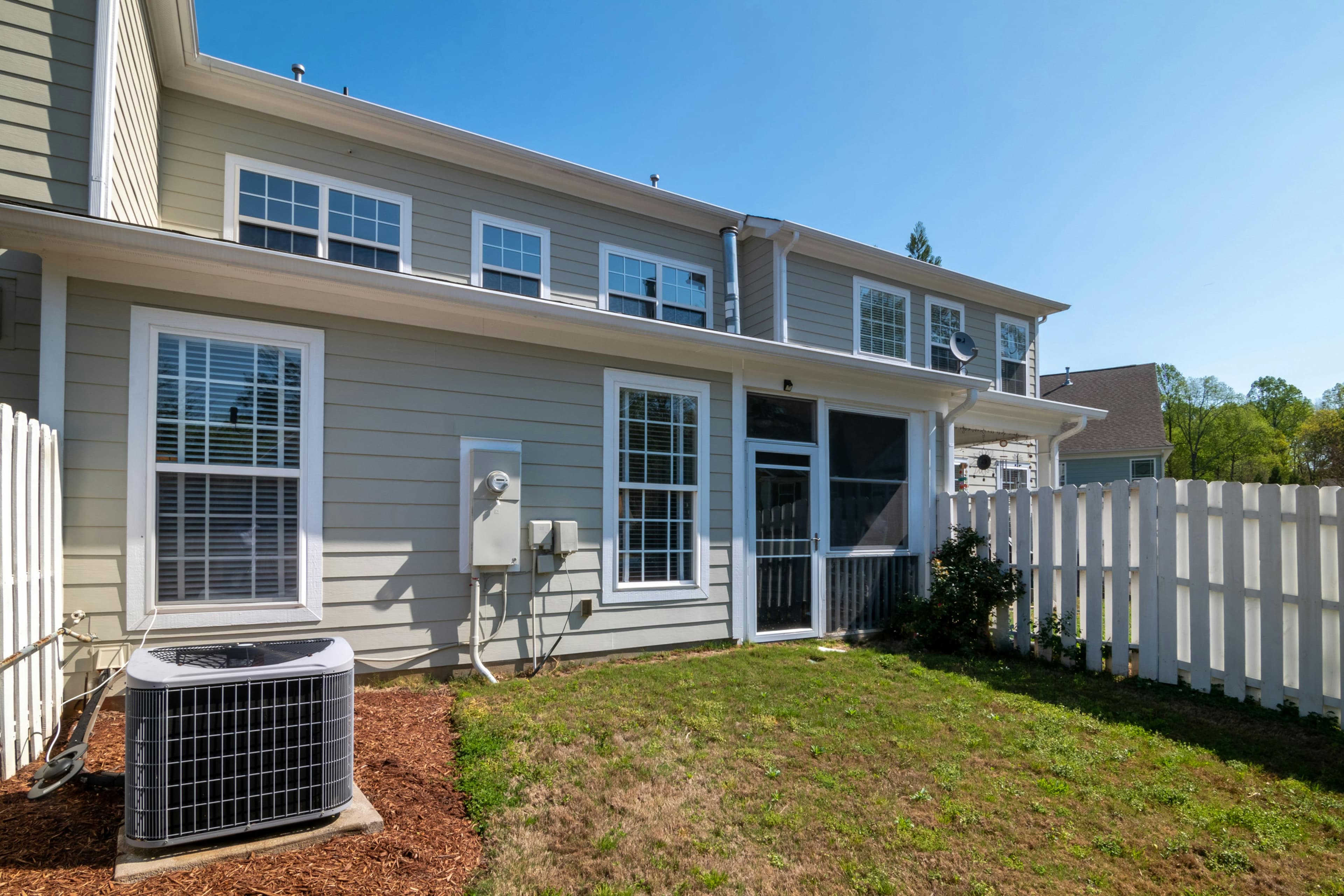 Residential HVAC equipment beside a Florida-style home